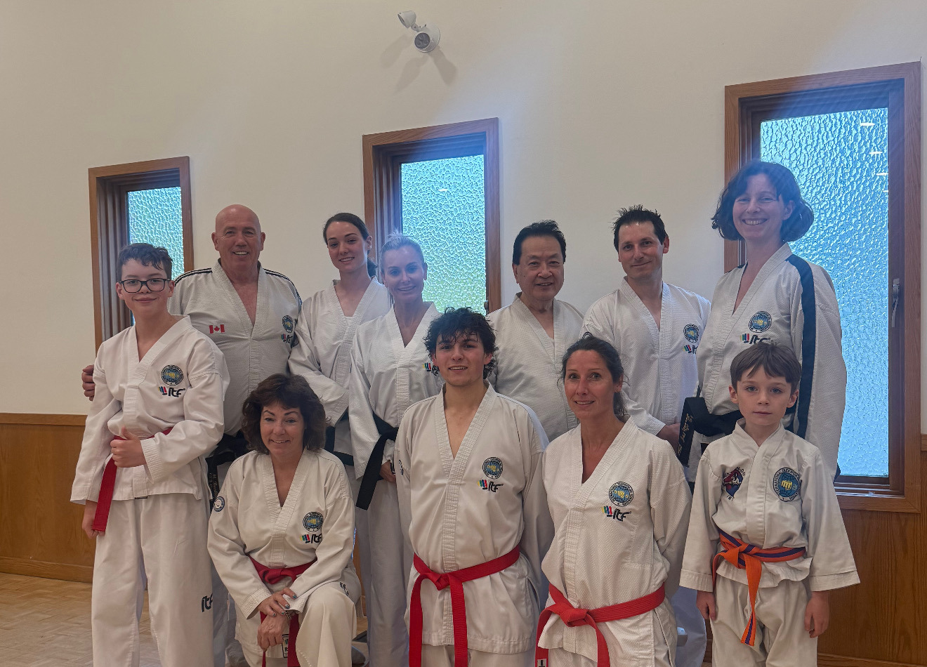 Teen and adult students with instructors at Impact Martial Arts